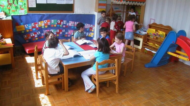 παιδάκια κάθονται σε τραπέζι παιδικού σταθμού