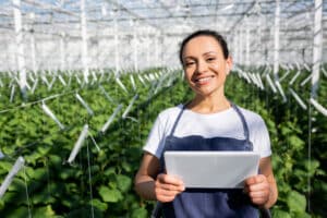 stock photo african american farmer digital tablet smiling camera greenhouse