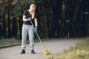 woman collects leaves cleans park 1157 27413