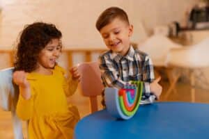 young boy girl playing indoors with eco toys 23 2150268068