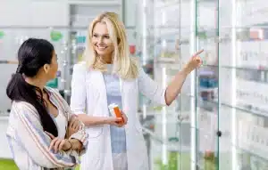 pharmacist consulting customer in drugstore e1718007377819