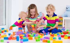 kids playing with colorful toy e1719838287345