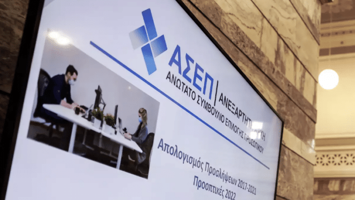 Οθόνη στην Βουλή στην οποία αποτυπώνεται το λογότυπο του ΑΣΕΠ. Βγήκαν οι 103 φορείς που θα πάρουν 6.158 μόνιμους (ΑΣΕΠ)